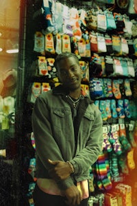 a man standing in front of a rack of socks